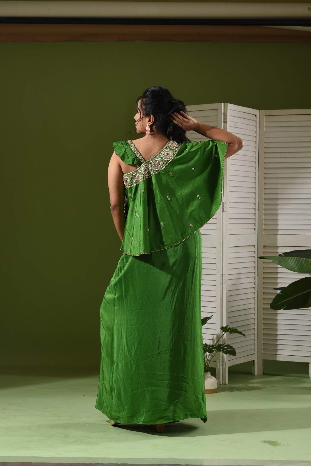 One shoulder cape , bustier and pull up skirt